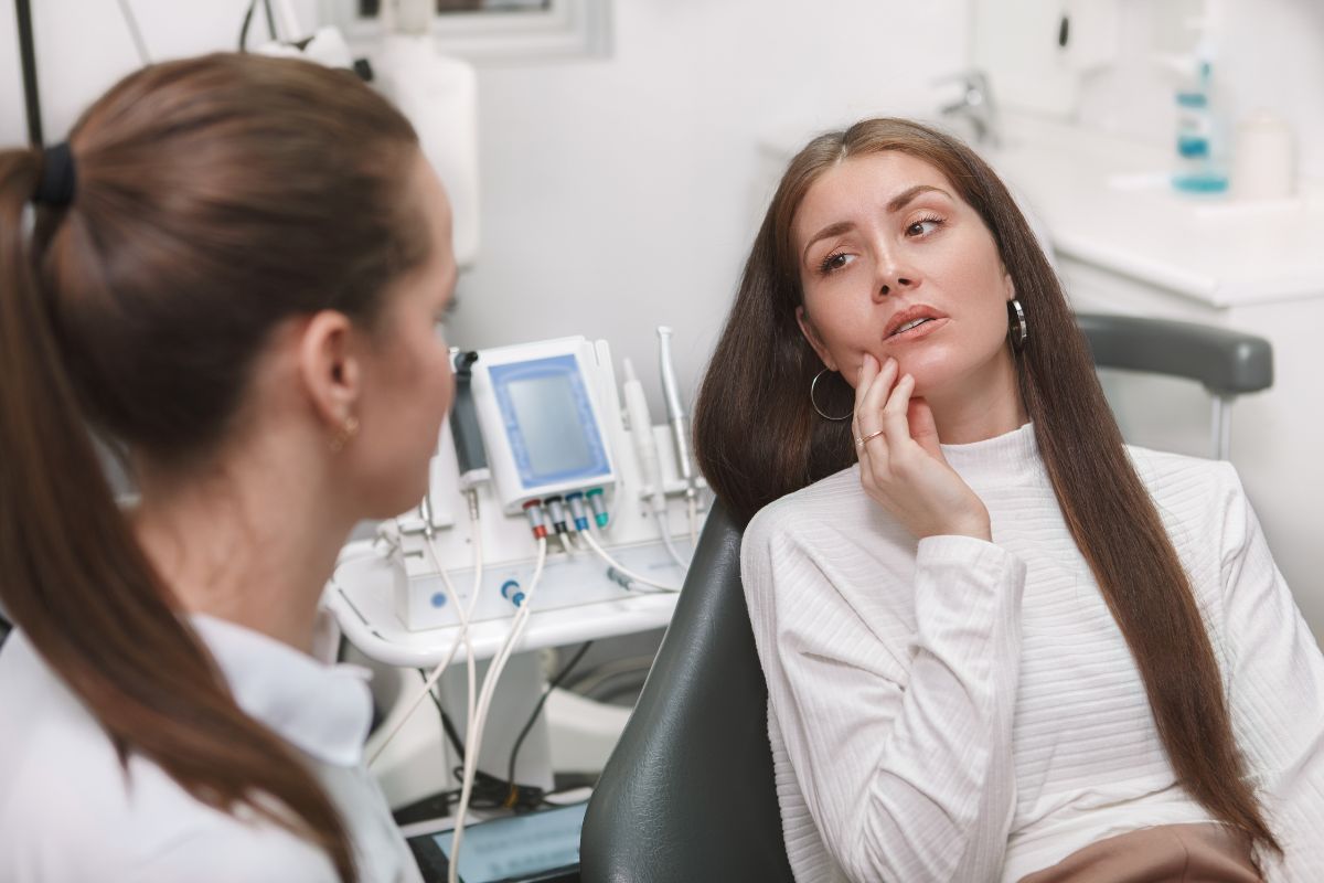 Emergency Dental Care Woman patient consulting with female healthcare provider in medical office with ultrasound equipment.